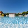 Piscina all'aperto con scivoli e ombrelloni.