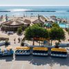 Spiaggia con ombrelloni, trenino e vista sul mare.